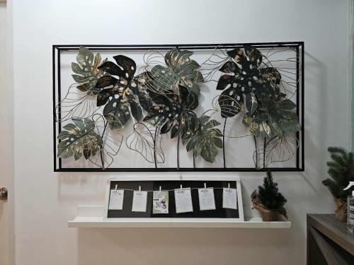 a display shelf with plants on a wall at RDC Cozy Suite in Tagaytay