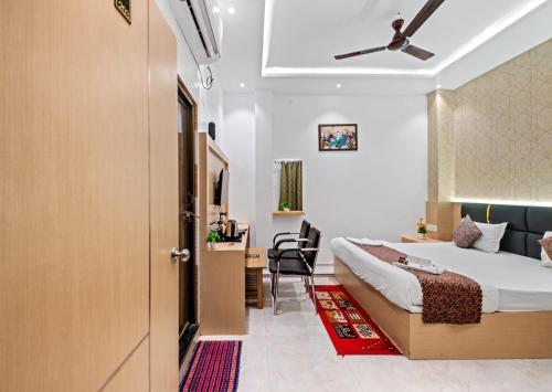 a hotel room with a bed and a desk at Hotel Ramay Palace in Ayodhya