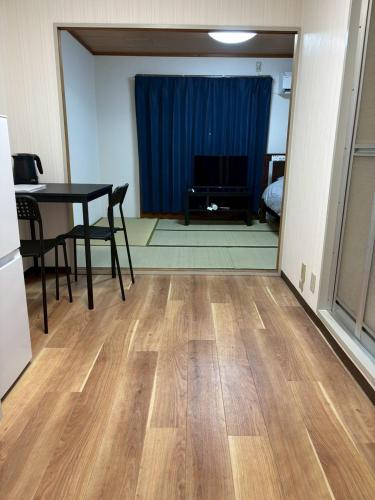 a living room with a table and a dining room at お宿あびこシルバーハイツ in Osaka
