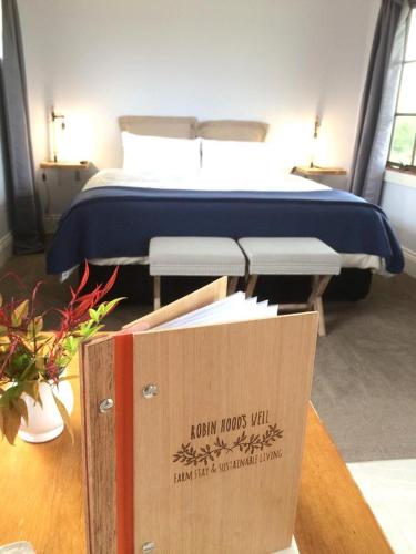 a bed in a room with a box next to it at Robin Hoods Well Farm Stay in Sassafras