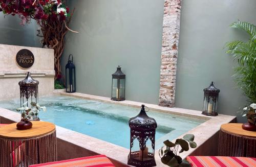 a swimming pool in a house with vases in it at Casa Pandurata Luxury Apartments in Centro, San Miguel de Allende in San Miguel de Allende