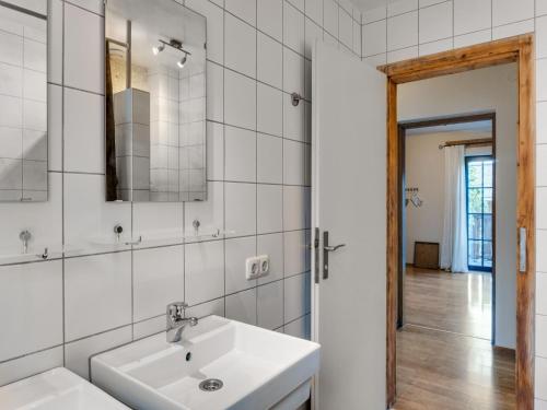 a white bathroom with a sink and a mirror at Chalet in Leogang near Ski Lifts in Leogang