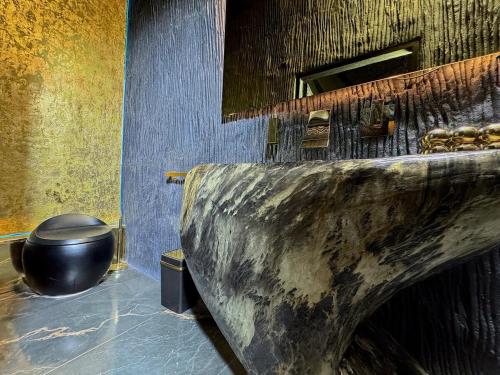 a bathroom with a stone sink and a toilet at Luxury Cabin Eleven Eleven in San Rafael
