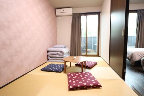 a hotel room with a table and a chair at Kyostay Iroha Toji Annex in Kyoto