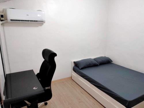 a bedroom with a bed and a desk and a chair at Prime City Location - 3 Bedroom Unit in Lapu Lapu City