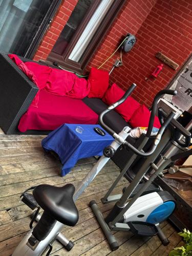 an exercise bike and an umbrella next to a bed at PVT Hostel in Montréal