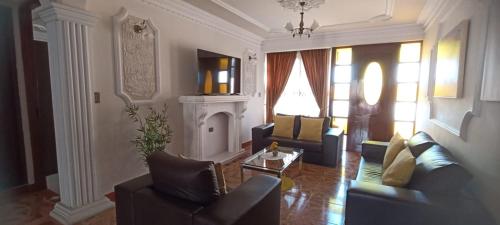 a living room with two couches and a fireplace at Como en casa para familia con niños in Sucre