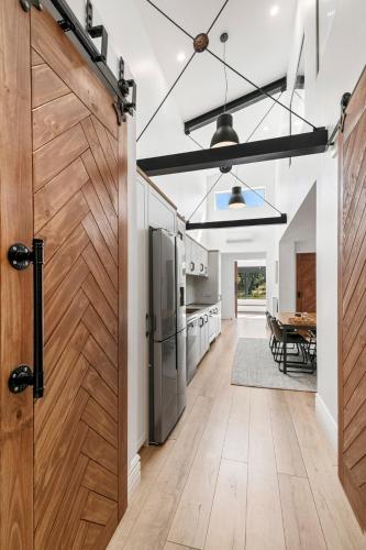 a barn door in a kitchen with a table at Elbert at Lake Crackenback Resort in Crackenback