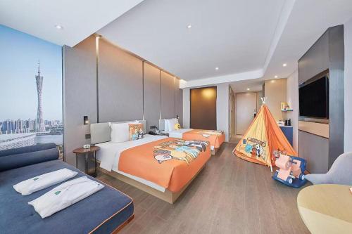 a hotel room with two beds and a tv at Atour Hotel Shunde Midea Yueran Plaza Foshan in Shunde