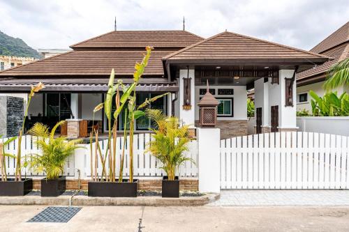 a white fence in front of a house at Cozy Pool Villa near Kamala - 850 meter to the beach in Kamala Beach