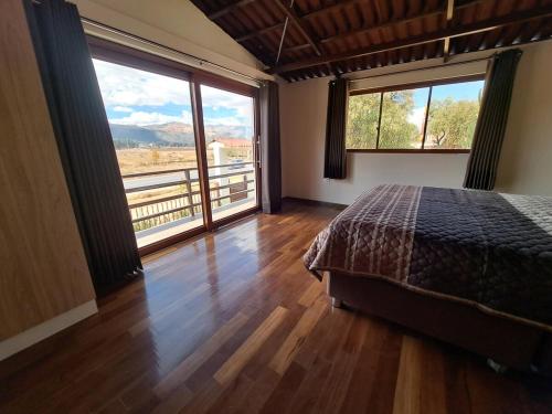 a bedroom with a bed and a large window at Centro recreativo y Casa de campo in Orcotuna
