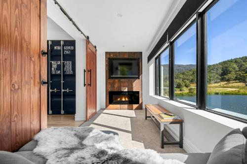 a living room with a couch and a fireplace at Elbert at Lake Crackenback Resort in Crackenback