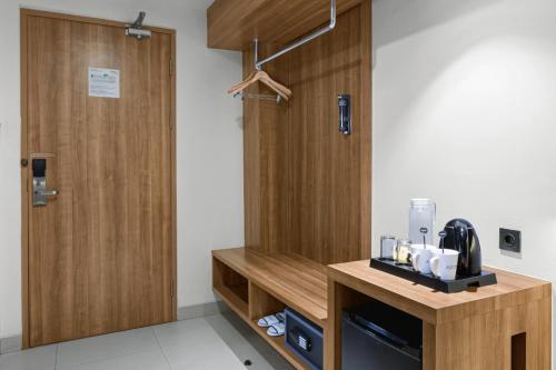 a kitchen with a wooden partition and a counter with a appliance at Aston Sidoarjo City Hotel & Conference Center in Sidoarjo