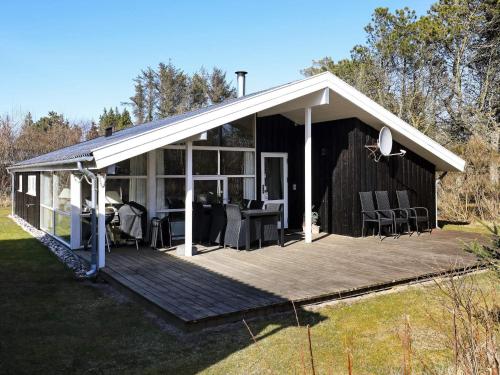 a pavilion with a table and chairs on a deck at 6 person holiday home in Blokhus in Blokhus