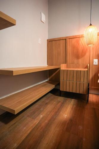 a room with a desk and a table and a lamp at Pousada Aconchego Noronha in Fernando de Noronha