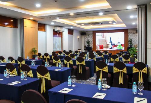 a banquet hall with blue tables and yellow bows at Oscar Saigon Hotel in Ho Chi Minh City