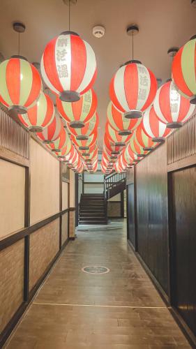 a hallway with red and white lanterns hanging from the ceiling at Lynn Times Thanh Thuy Onsen Hot Spring in La Phu