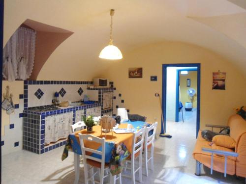 a kitchen and dining room with a table and chairs at Appartamento Gallipoli in Gallipoli