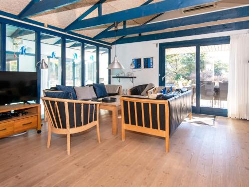 a living room with a couch and a table at 5 star holiday home in Ringkøbing in Klegod