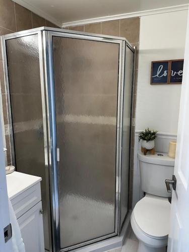 a shower stall in a bathroom with a toilet at Cozy 1 Bedroom Apt - Minutes to NYC - Great for Remote Work in North Bergen