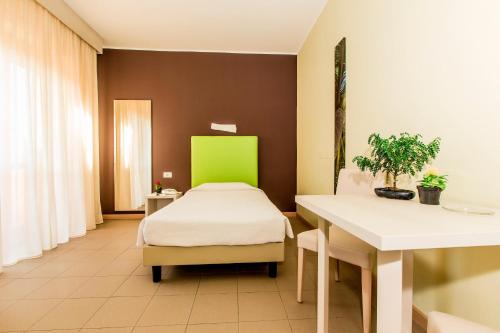Ένα ή περισσότερα κρεβάτια σε δωμάτιο στο Hotel Residence Ulivi E Palme