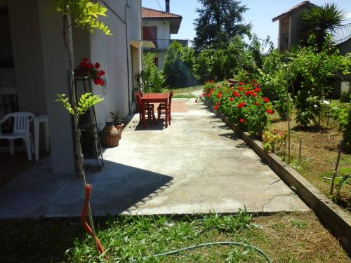 a walkway outside of a house with red flowers at B&B Tio Pepe in Roseto degli Abruzzi