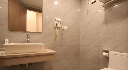 a bathroom with a sink and a toilet at 7Days Premium Yichang Railway Station East in Yichang