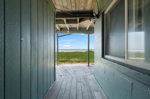 an open door to a barn with a view of the ocean at Crescent Beach Motel in Crescent City