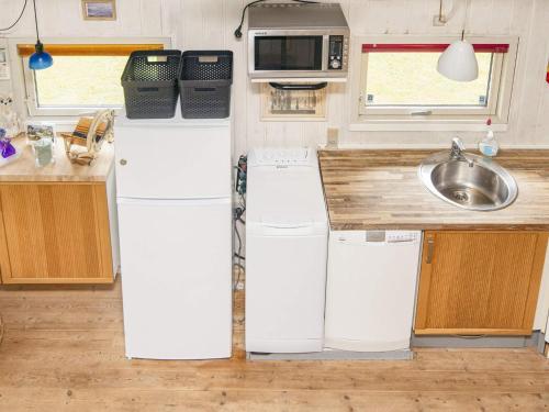 a kitchen with two refrigerators and a sink at 5 person holiday home in Hovborg in Hovborg