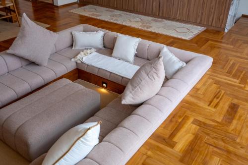 a living room with a couch and pillows at Sore Escape Tumbak Bayuh by Betterplace in Tumbak Bayuh