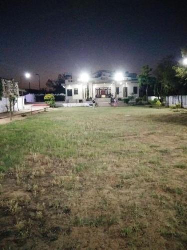 a house at night with lights in a yard at SHUBHAM ReSORT in Jaipur