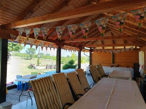 a dining room with tables and chairs in a pavilion at Dečiji vinogradi Belgrade, Sopot, Kosmaj in Sopot