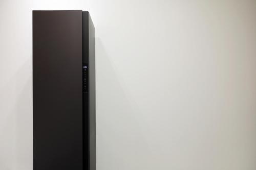 a black refrigerator standing next to a white wall at Chuncheon Intro Family hotel in Chuncheon