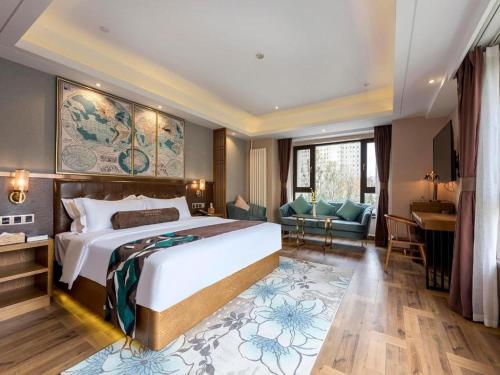 a bedroom with a large bed and a living room at James Joyce Coffetel Harbin West High-speed Railway Station Wanda Plaza in Harbin