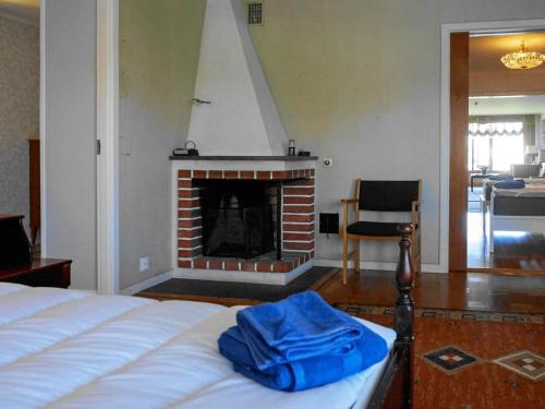 a bedroom with a bed and a fireplace at 7 person holiday home in SKÄRHAMN in Skärhamn