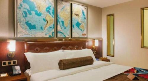 a bedroom with a large bed with a map on the wall at James Joyce Coffetel Guilin Railway Station Xiangbi Mountain Liangjiang Sihu Wharf in Guilin