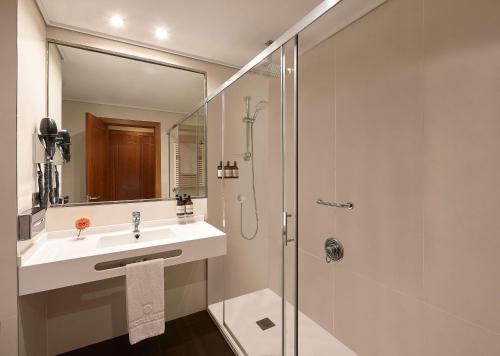 a bathroom with a sink and a shower at NH Collection Vigo in Vigo