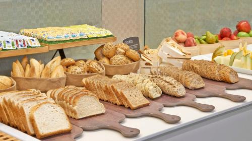 a display of different types of bread and pastries at NH Ciudad de Zaragoza in Zaragoza