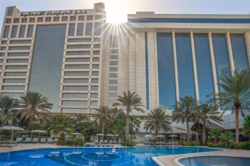 a view of the mgm grand hotel from the pool at The Diplomat Radisson Blu Hotel Residence & Spa in Manama