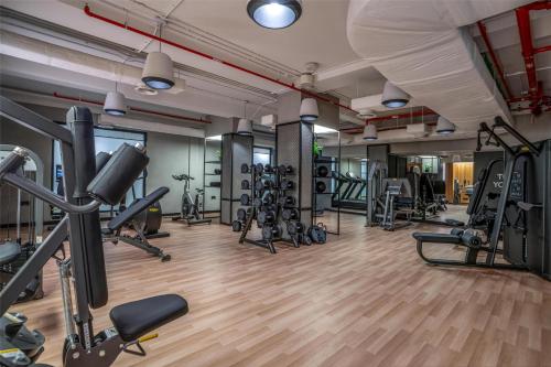 a gym with several treadmills and cardio machines at The Diplomat Radisson Blu Hotel Residence & Spa in Manama