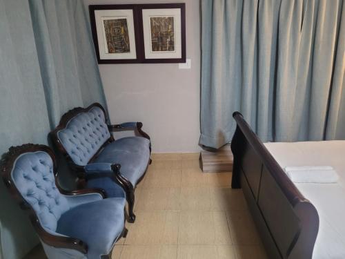 a hospital room with two chairs and a bed at Prime Executive Accommodation in Cape Town