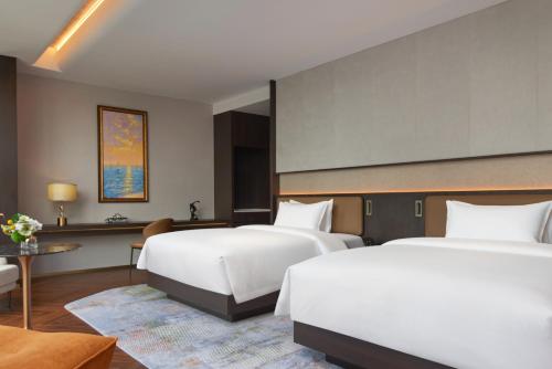 Jin Jiang International Hotel Mianyangにあるベッド