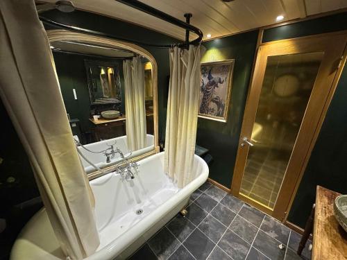 a large bathroom with a tub and a shower at Selene Unique Luxury Houseboat Experience in Chertsey