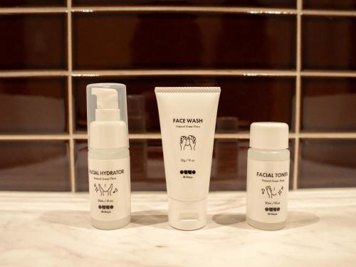 three bottles of sunscreen sitting on a bathroom counter at illi Jam Shinsaibashi in Osaka