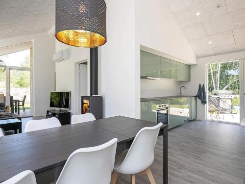 a dining room with a table and white chairs at 8 person holiday home in Læsø-By Traum in Læsø