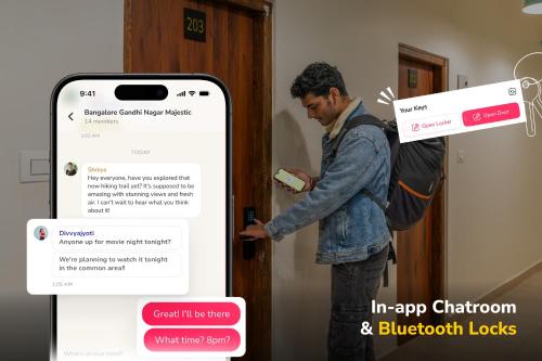 a man standing at a door holding a cell phone at goSTOPS PLUS Kasol, Suma Ropa in Kasol