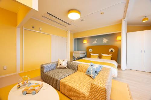 a hotel room with a couch and a bed at Kamogawa Grand Hotel in Kamogawa
