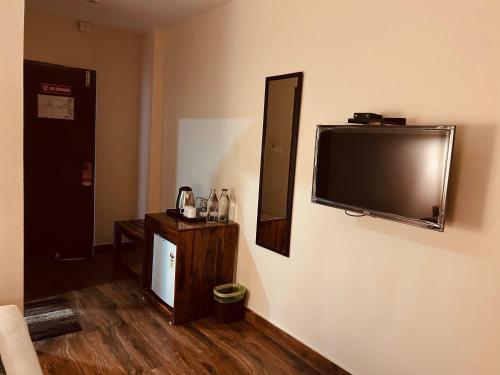 a room with a flat screen tv on the wall at SeaScape Port Blair in Port Blair
