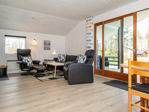 a living room with a couch and two chairs at 4 person holiday home in Toftlund in Toftlund
