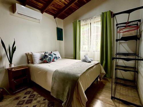 a bedroom with a bed with a green curtain at Cabañas Litos #2 in Fortuna